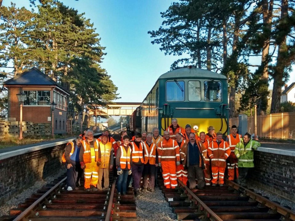 Volunteers line up in front of the first train to the new Broadway Station // Credit Jo Roesen