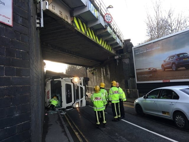 Overturned lorry after hitting railway bridge