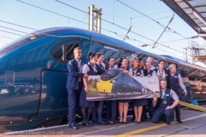 Staff stand next to Class 390 Pendolino at Preston