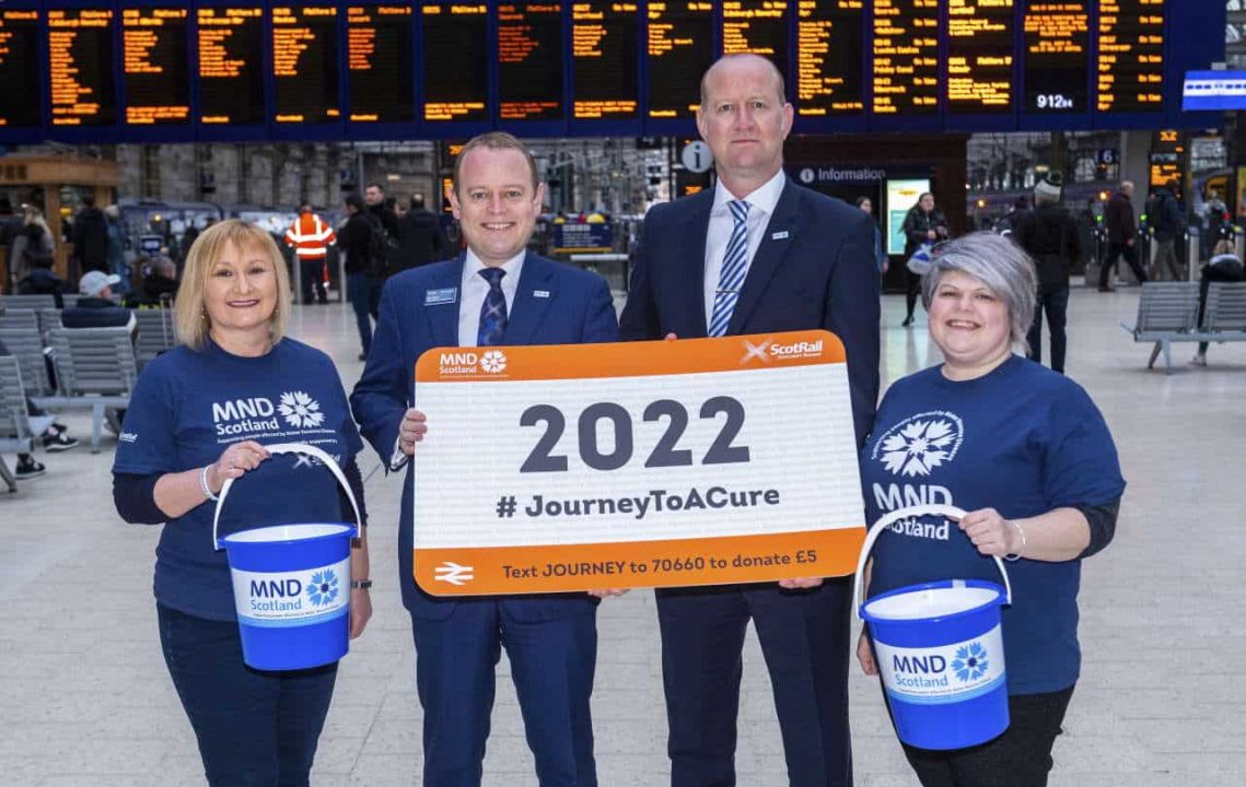 GLASGOW, SCOTLAND - FEBRUARY 05: ScotRail joins up with MND Scotland as part of the 2022 Journey to Care in Glasgow Central Station on February 05, 2020. Pictured: Alex Hynes, (Managing Director of Scotland’s Railway) and Iain McWhirter (Head of Fundraising MND Scotland) alongside members of Staff from MND Scotland and Scotrail Alliance. (Photo by Bill Murray / SNS Group)