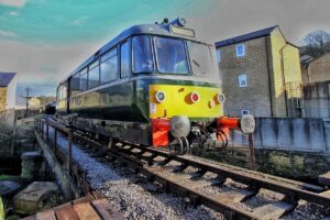 Diesel railbus passes over Bridge 11 on the Keighley and Worth Valley Railway