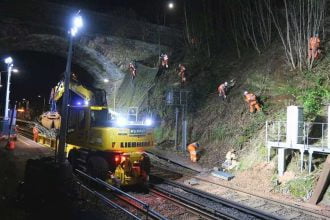 Rail workers abseil slope to keep essential workers on the move