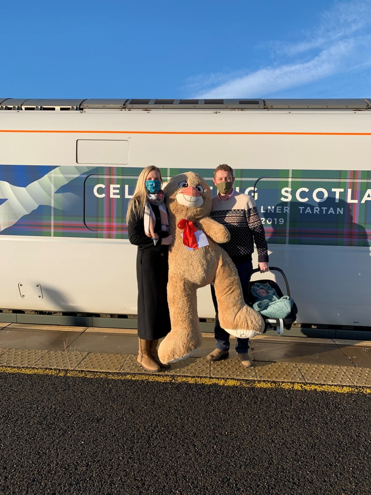 The bear with Major Tim and Dr Emily Barker at Leuchars