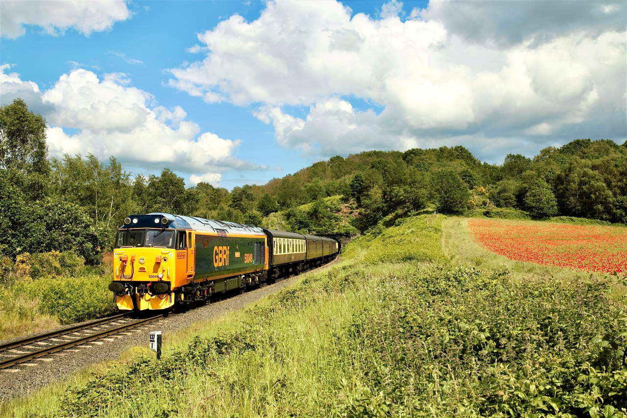 50049 Defiance leaves Bewdley tunnel past the poppy fields with the 1455 Kidderminster-Bridgnorth