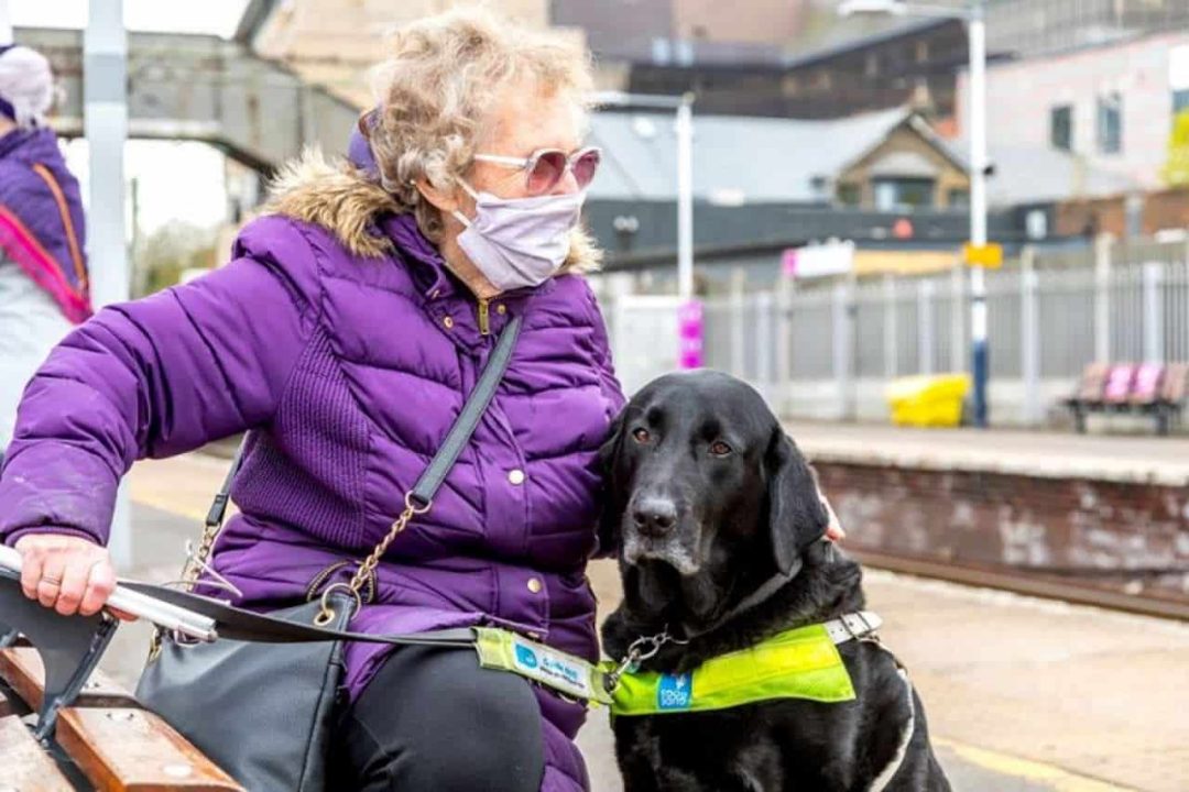 A Woman and her dog on a station