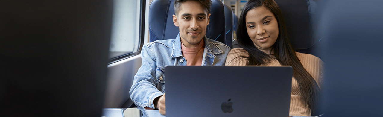 two people on the train with a laptop