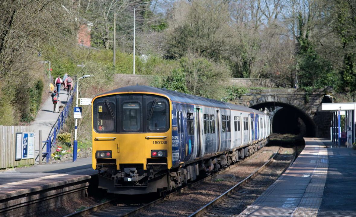 Northern 150128 and 150136 head out of Disley on the 12.08 Manchester Piccadilly to Buxton 190322