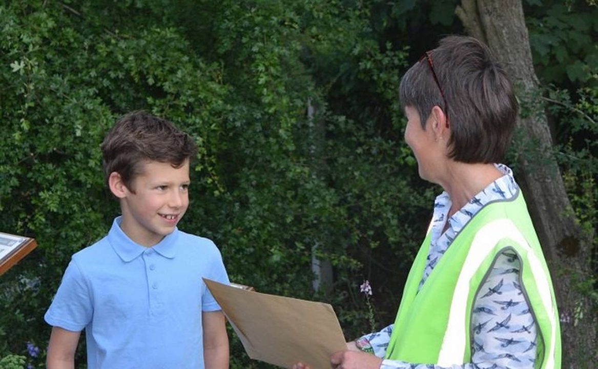 Sandy Burn, Westerfield station adopter, presents Elliot Clarke with his prize.