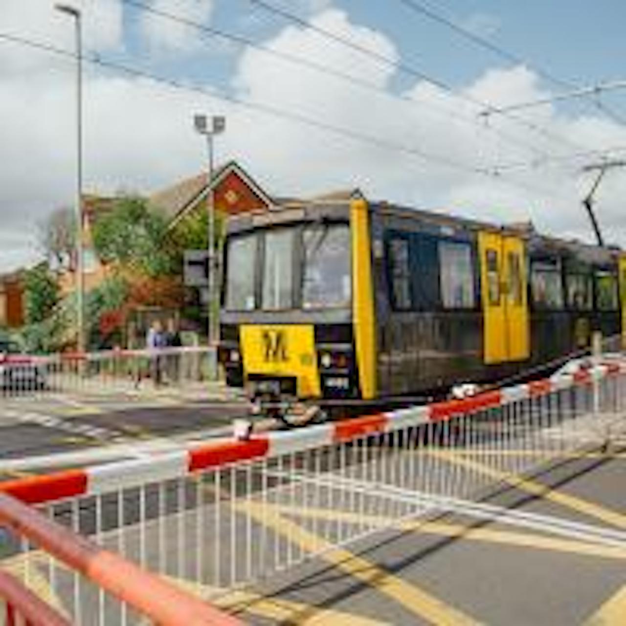 Metro train at level crossing