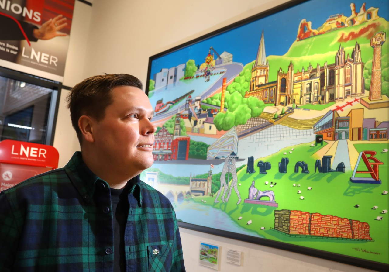 Artist Tom Wriglesworth pictured beside his ‘Wonderful Wakefield’ artwork at Wakefield Westgate station