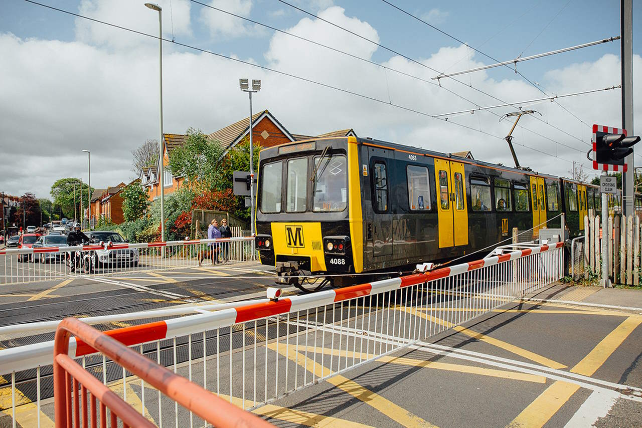 Metro train at level crossing