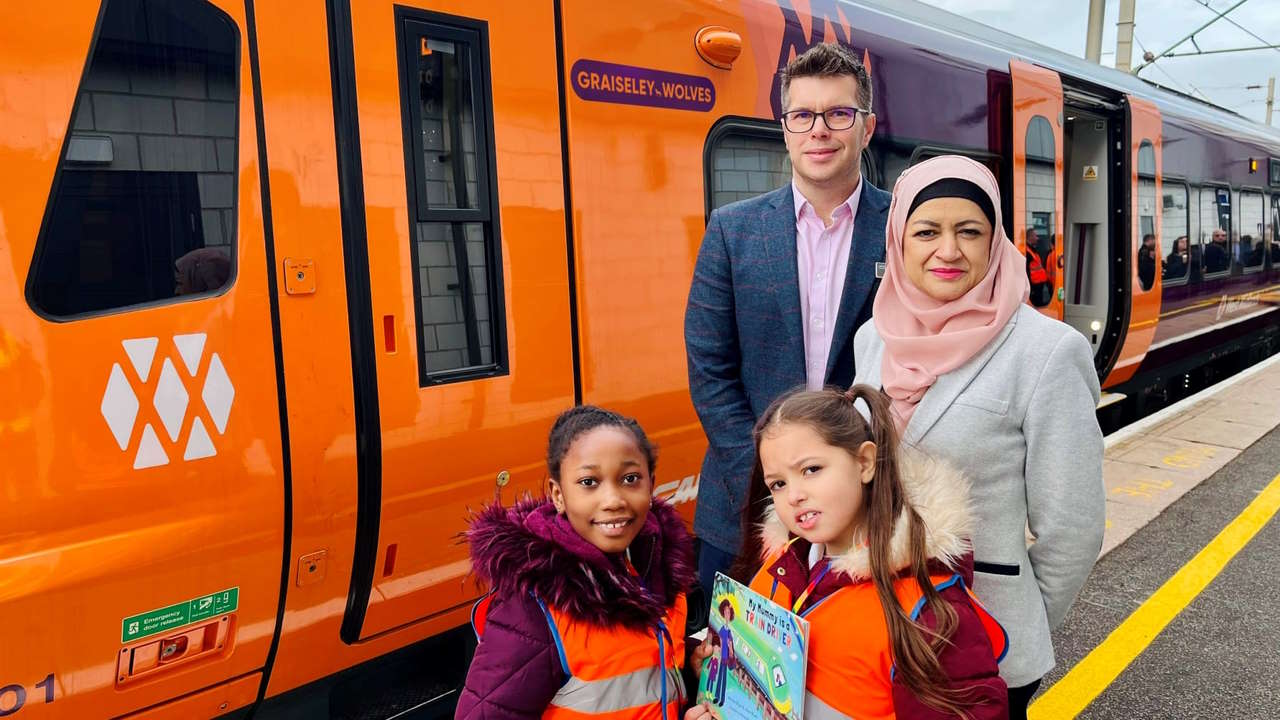 WMR customer experience director Jonny Wiseman, head teacher Sharifan Nasa and school children with the Graiseley Wolves train