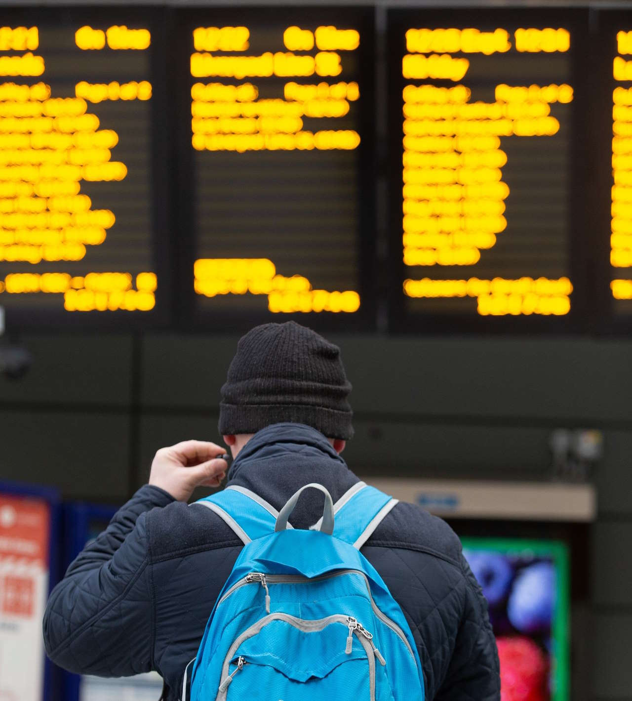 Image shows customer at departure screens