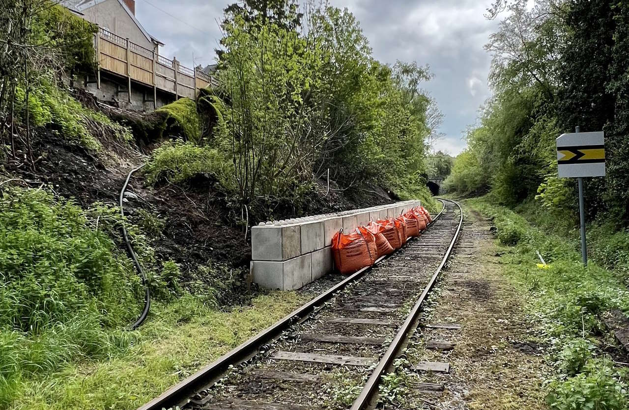 The trees you see just above the concrete blocks were at the top of the cutting before the slip took place.