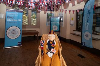 Southeastern decorates its stations for the Coronation weekend including a life-sized knitted King!