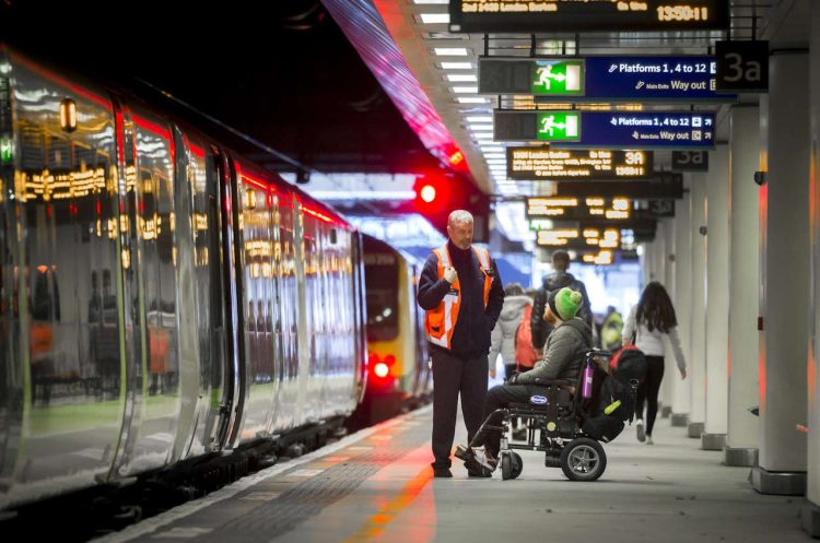 Wheelchair user being assisted by platform staff