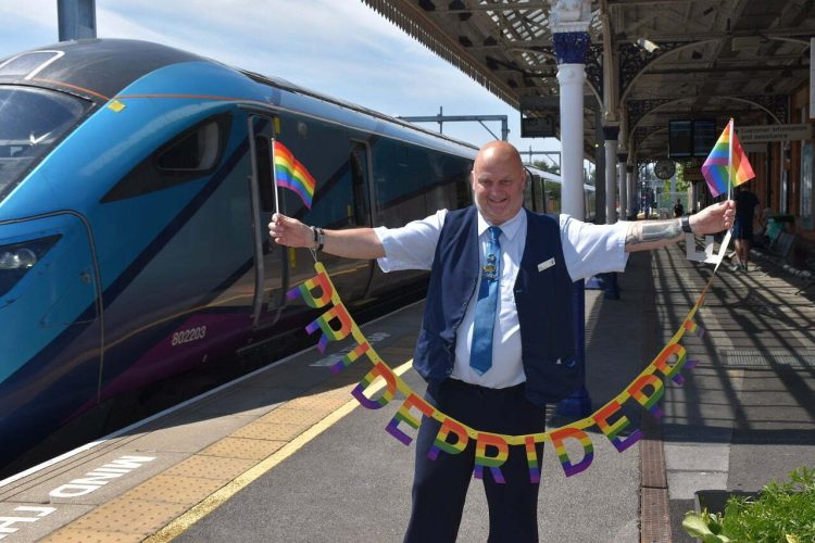 Robert Dixon, Stalybridge Station Customer Service Supervisor for TPE showing TPE Pride banner and Flag