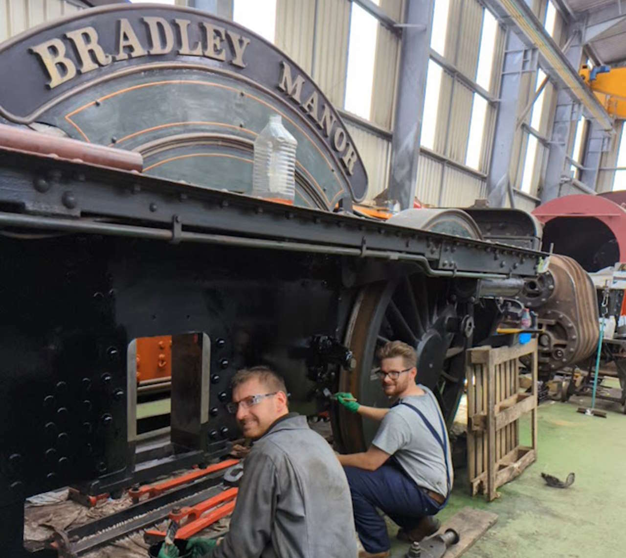 On 22nd July, trustee Chris Field and volunteer Ben Morris are seen happy in their work painting the frames in the space that the driving wheelset will occupy once replaced