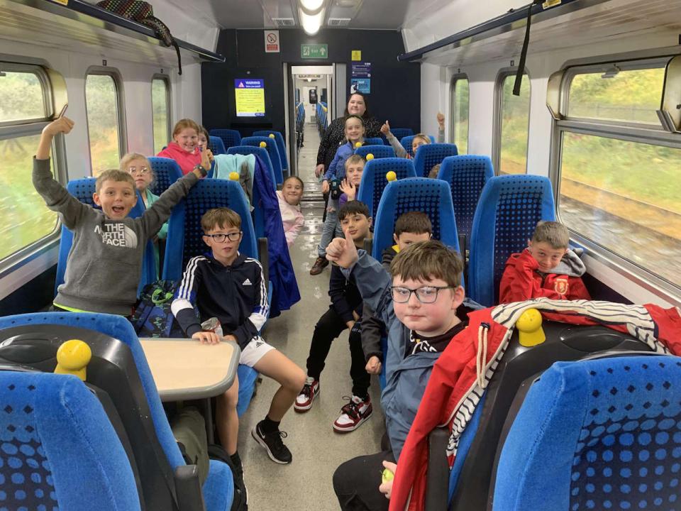 Children from Shackles off enjoying their trip on a Northern train