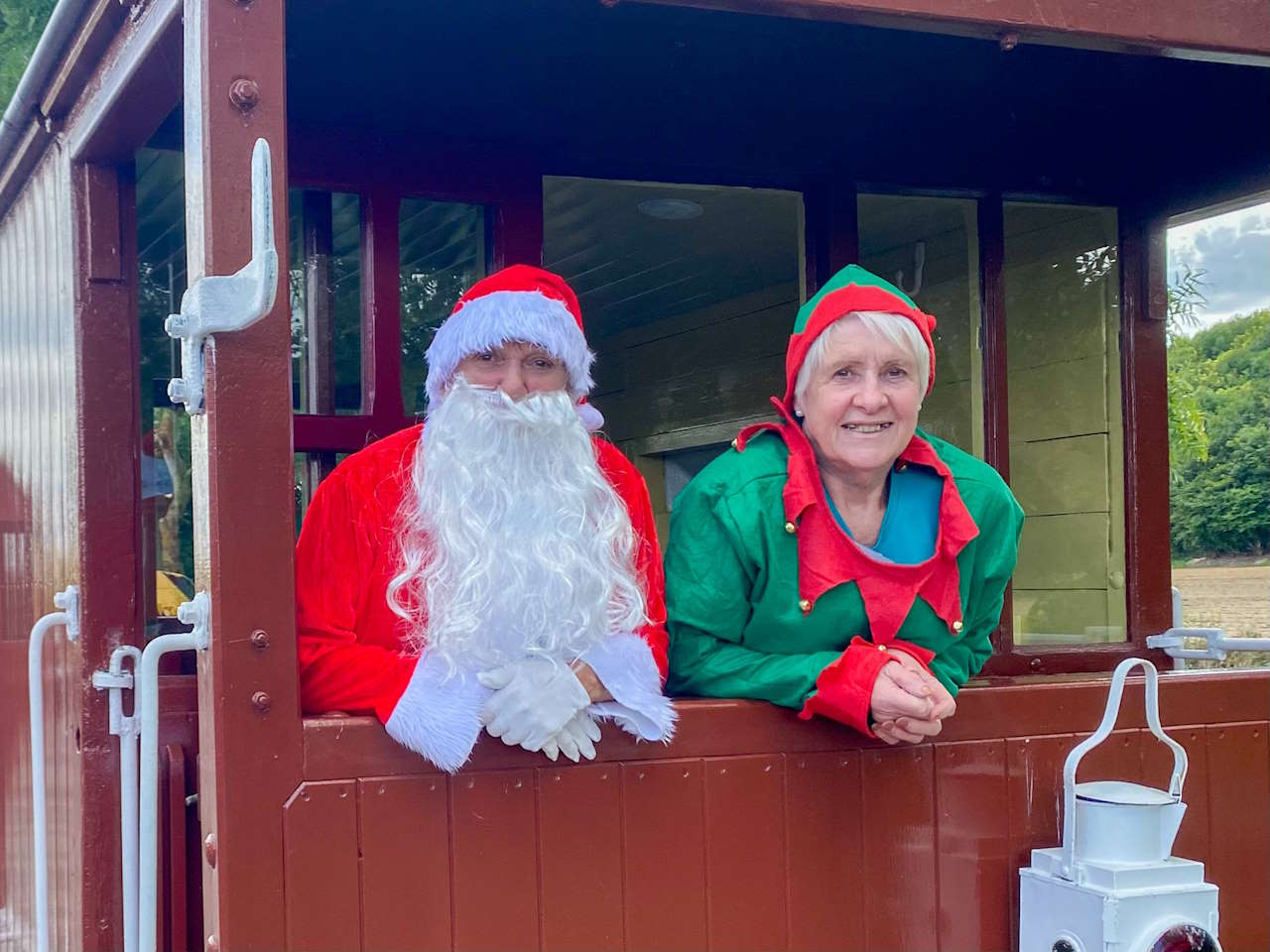 Father Christmas and an Elf on board the brake van at the YWR