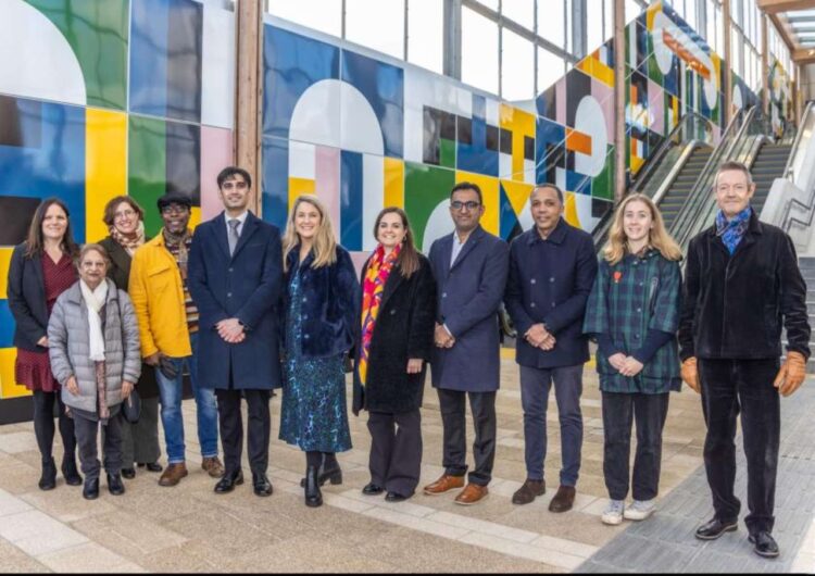 Members of the Barnet Cultural Steering Group pictured in front of Giles Round frieze, 'Time passes & still I think of you', at Brent Cross West station