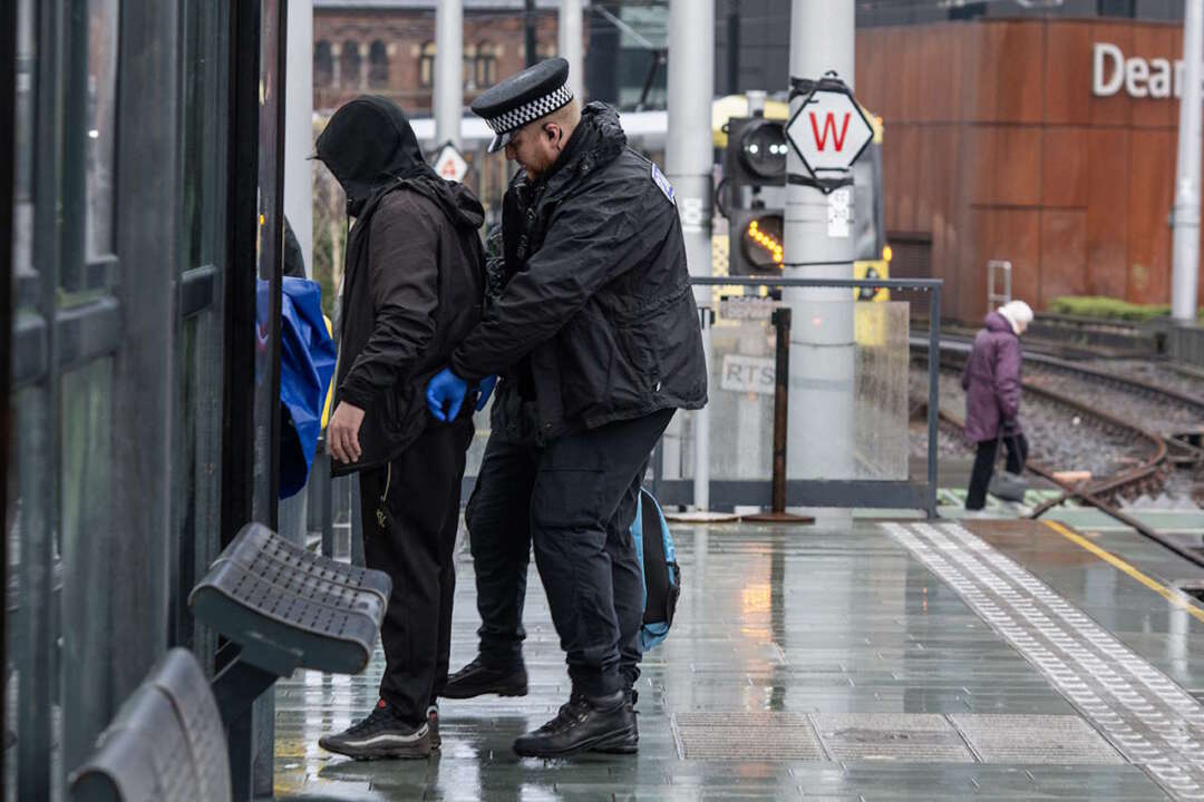 Officers carry out a stop search at Deansgate Castlefield