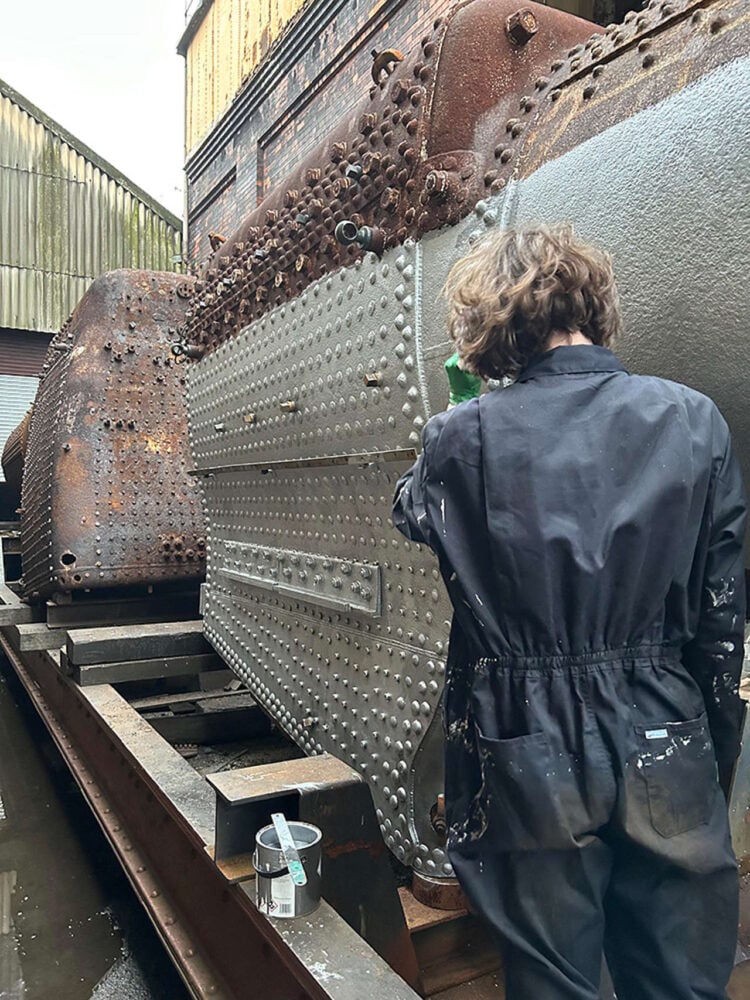 Volunteer Ewan Creese improving the boiler's appearance. // Credit: Martin Creese