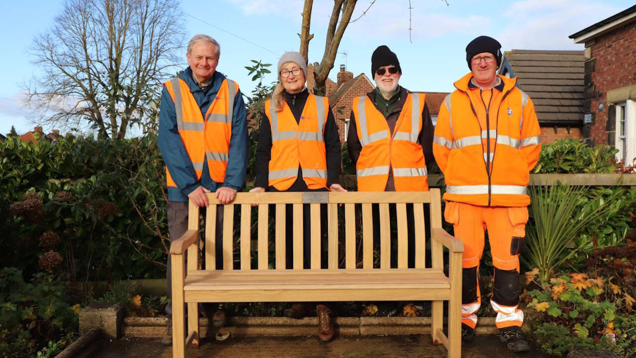 the poppleton memorial bench alongside station volunteers