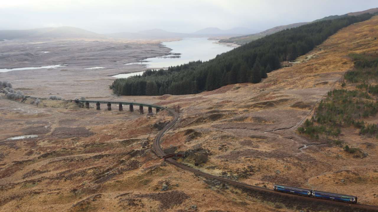 A ScotRail Train approaches Rannoch Viaduct