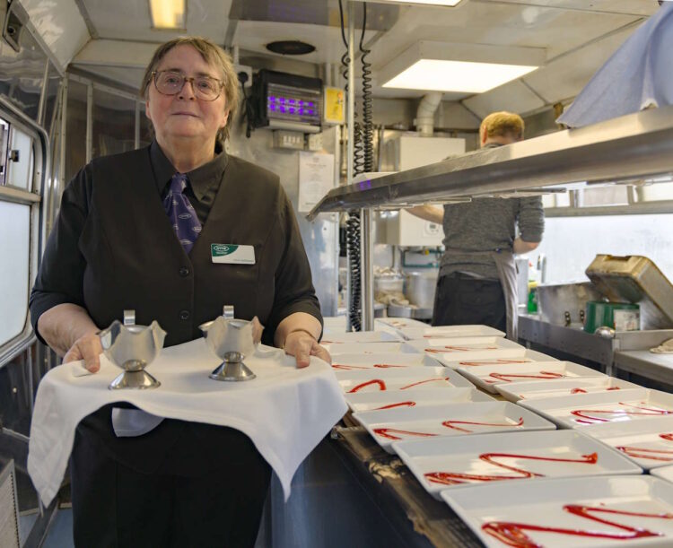 Volunteer Chris Kettlewell in the Pullman dining car. // Credit: Tim Bruce