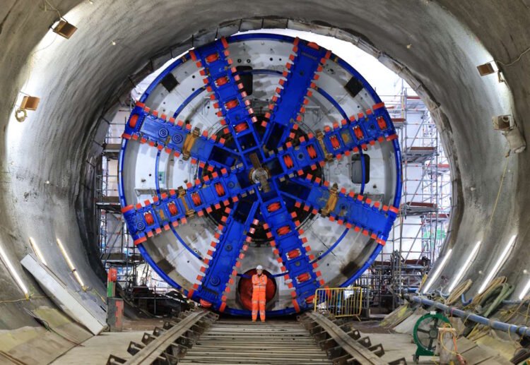 Construction worker posing in front of the Tunnel Boring Machine. // Credit: HS2