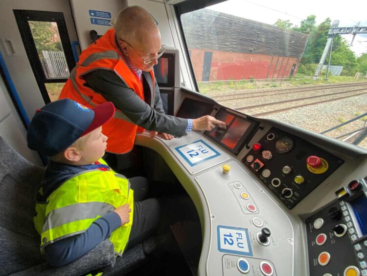 Driver manager Barry Minall shows Alfie the cab controls - Govia Thameslink Railway