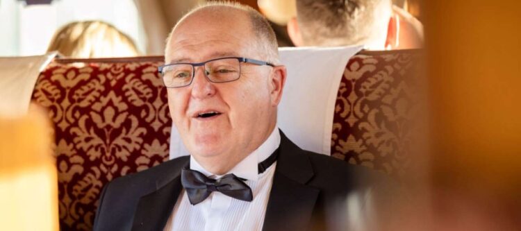 A father in his dinner suit on an ELR train.