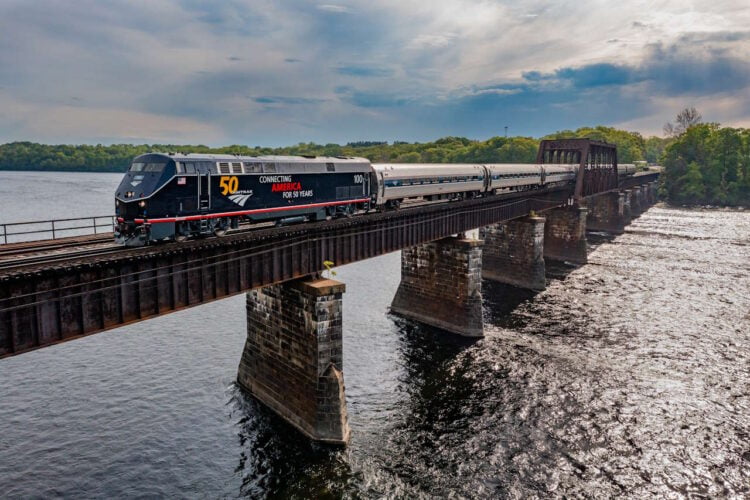 50th anniversary commemorative painted. locomotive crossing the Connecticut River at Enfield, Connecticut. // Credit: Amtrak