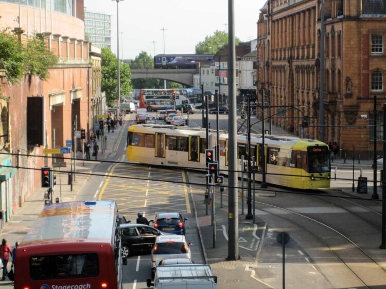 A Metrolink tram crosses the London Road - Manchester Metrolink