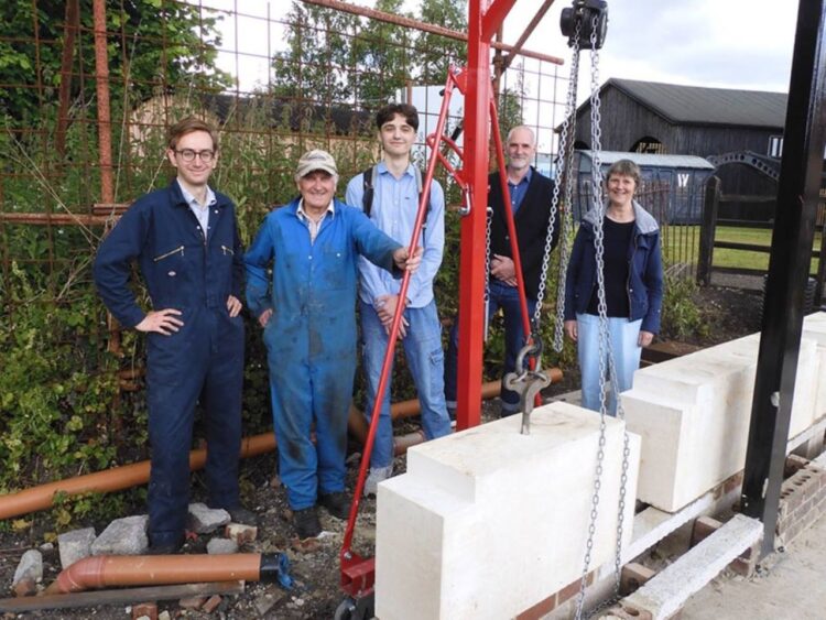 Didcot volunteers, Tom Sweeney, Alan Whiffen and Ann Middleton, flank Zeb and Jim Noble, with the newly laid stone in the foreground - Didcot Railway Centre