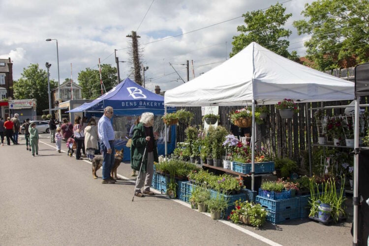 Mini market at the plaque unveiling at Highams Park station. Credit: John Murray