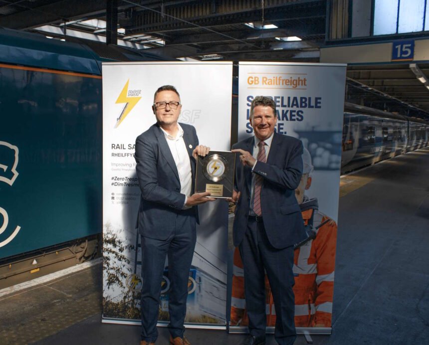 Stuart Heaton, Managing Director of Learn Live and Rail Safe Friendly presents the Rail Safe Friendly Gold Disc to John Smith, CEO of GB Railfreight at Euston Station