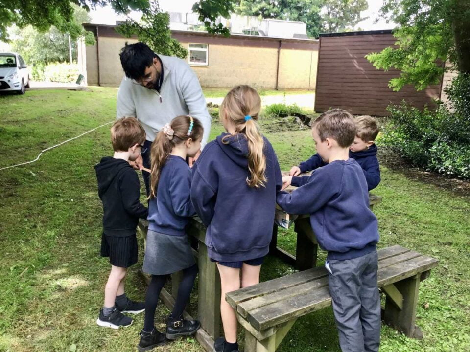 Students helping to create a bug hotel for Gargrave station - Northern