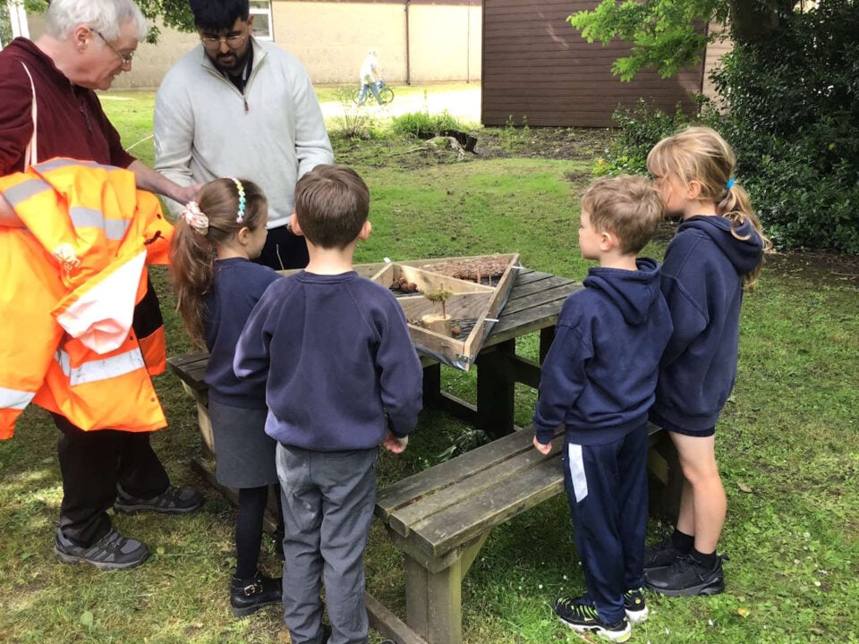 Sarvan Kahlon,  Year in industry student,  working with children creating insect hotel.