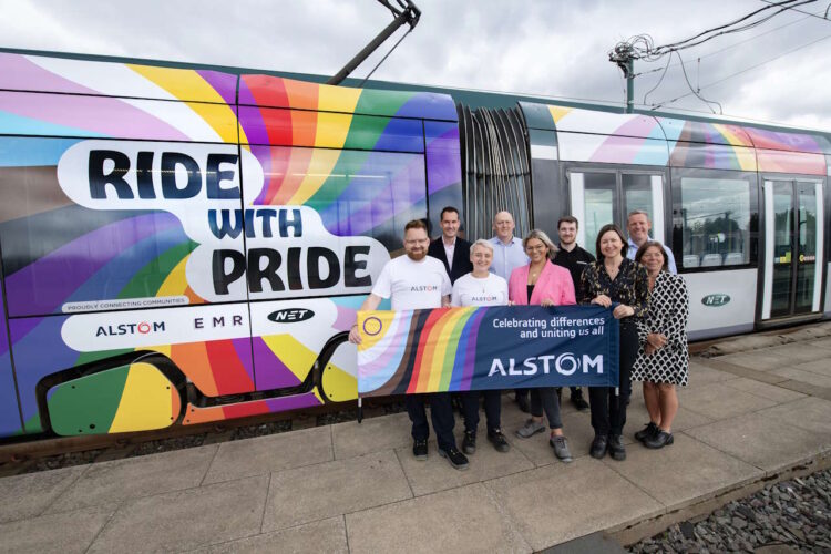 Alstom staff next to tram 213 reliveried in in Pride livery. // Credit: Nottingham Express Transit