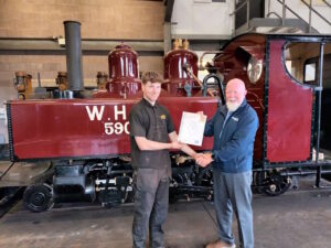 Neil Morrison (right, training assessor) congratulates Kian Holdsworth (left) on the completion of his apprenticeship at the Vale of Rheidol Railway