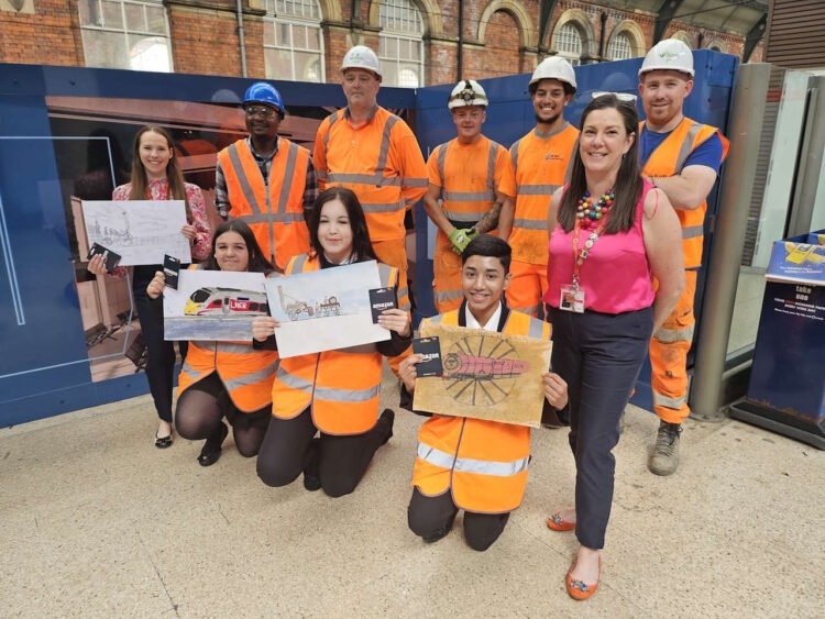 Wyvern Academy students with their winning designs and BAM Nuttall contractors at Darlingotn station. // Credit: Network Rail