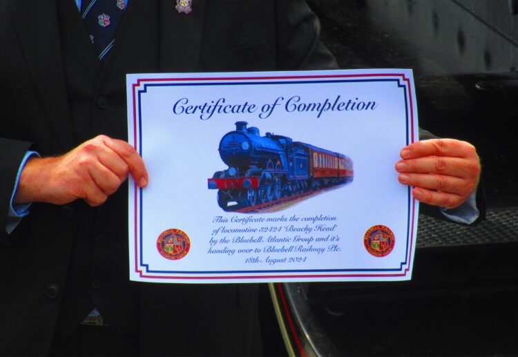 Neil Glaskin shows the presentation certificate handing the completed Brighton Atlantic over to the Bluebell Railway plc - Mark Wilson