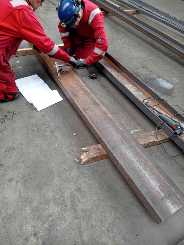 The apprentices mark out the holes to be drilled on the steel, provided by Walter Watsons Ltd - Downpatrick and County Down Railway