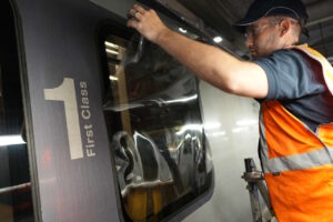 Window film being installed on a TPE train