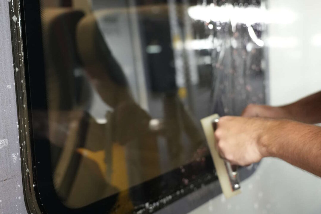 Window film being installed on a TPE train 