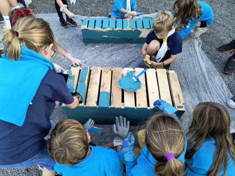 Cub scouts painting the planters. // Credit: Greater Anglia