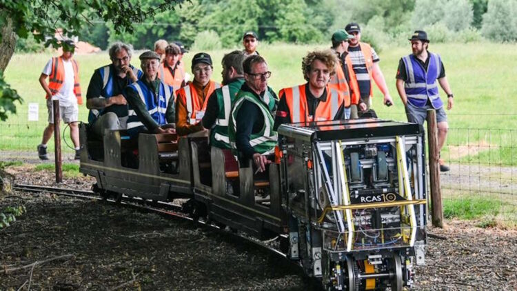 The team riding the course with their train