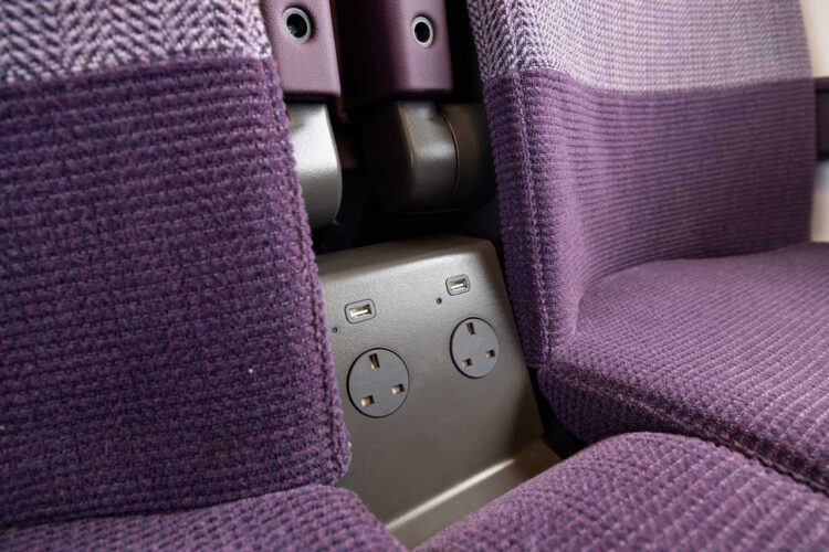 Three pin and USB charging points under the arm reast between the seats - East Midlands Railway